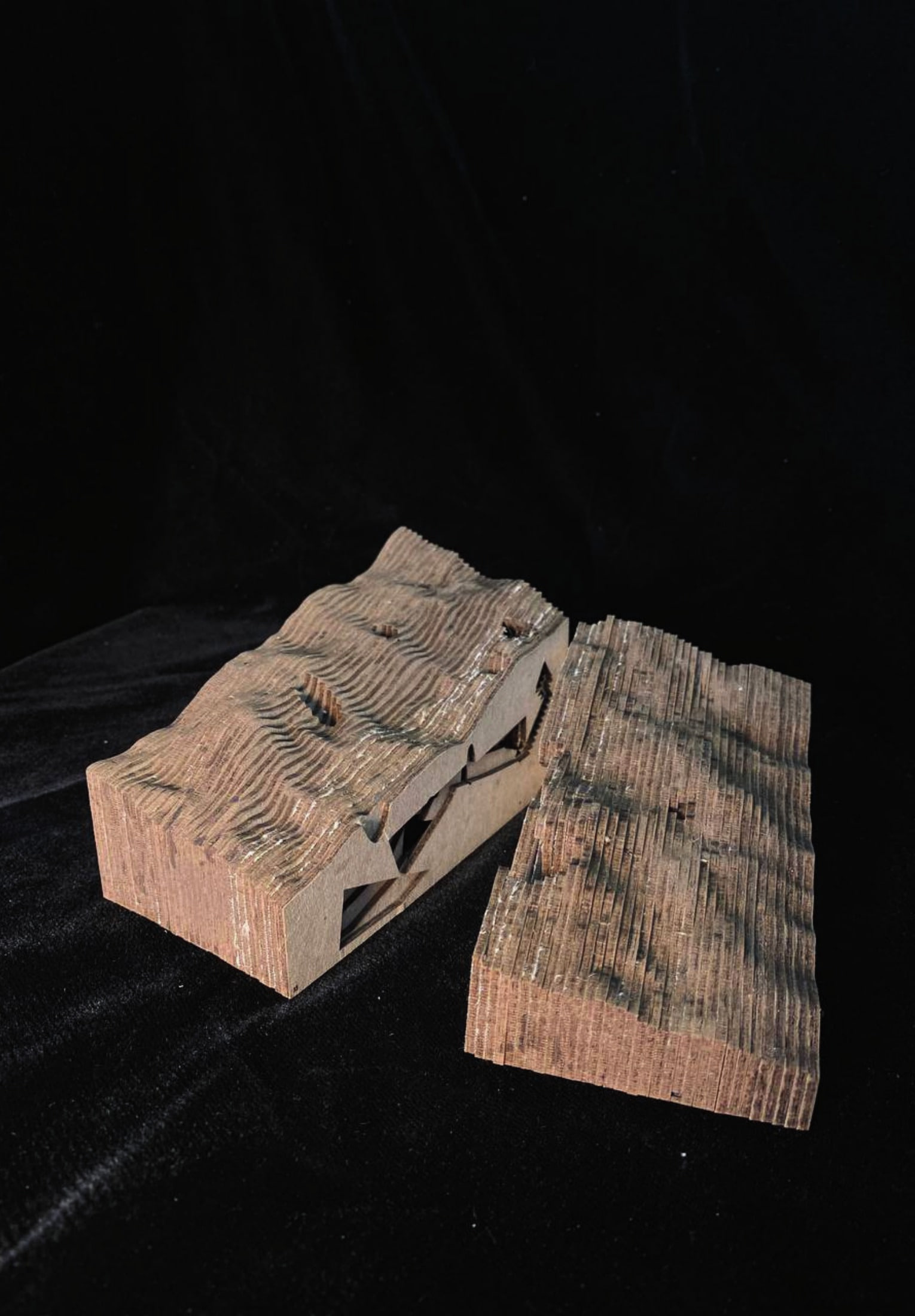Coastal Cave terrain model, laser-cut contours split open to reveal carved chambers